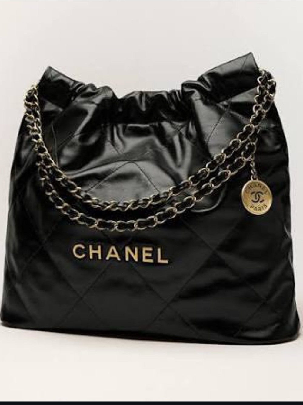 CHANEL Black Quilted Shoulder Bag with Gold Chain and Logo Charm